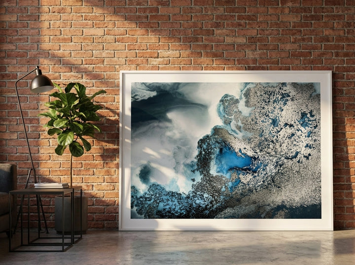 Oversized statement modern wall art print leaning against the wall in an industrial loft dining room