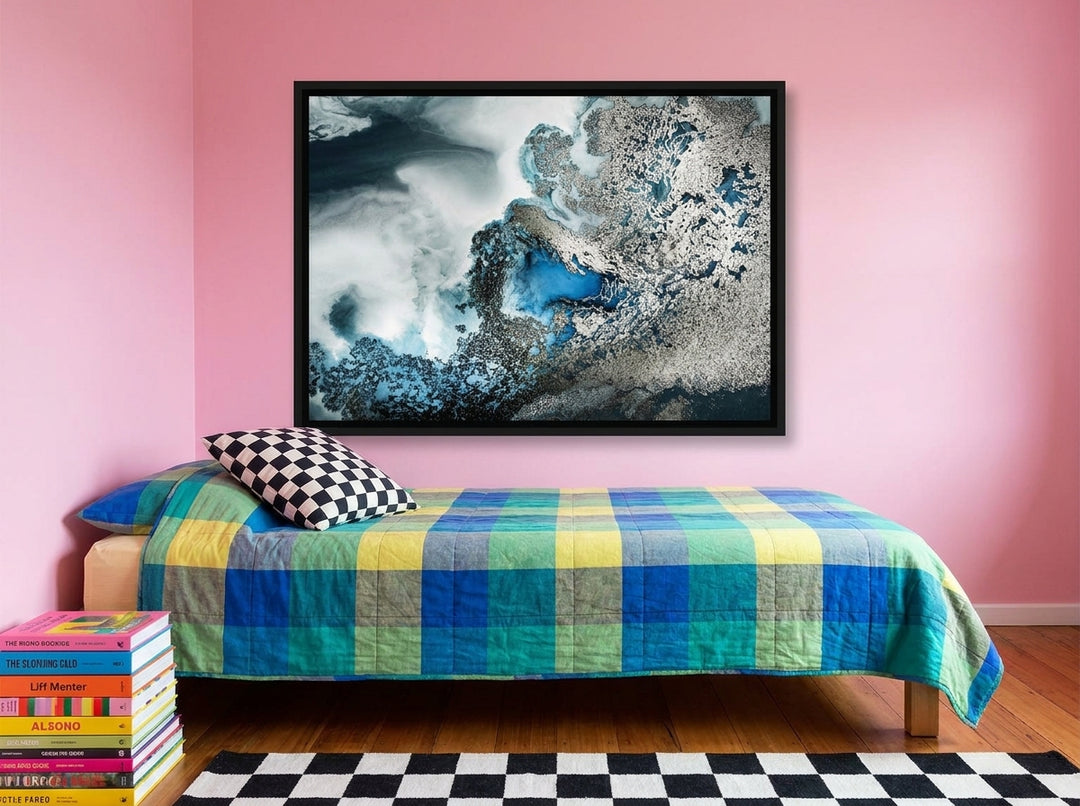 Canvas wall art with a black surround styled on the wall in a colourful eclectic bedroom
