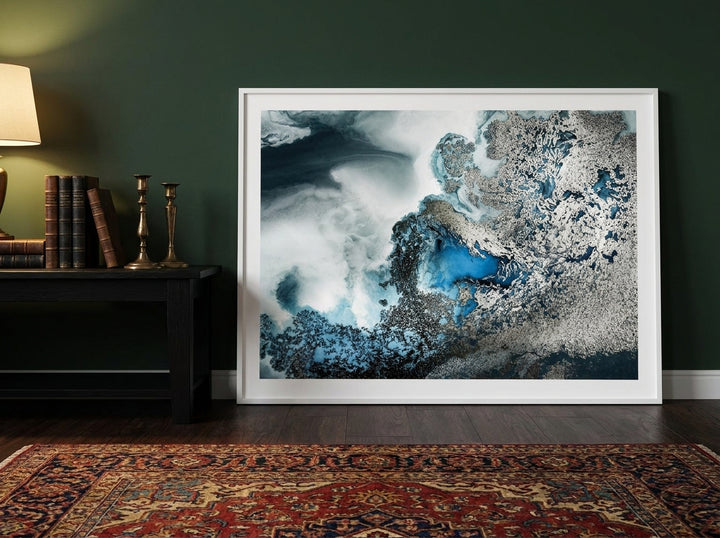 Modern wall art print standing on a console in a moody bedroom