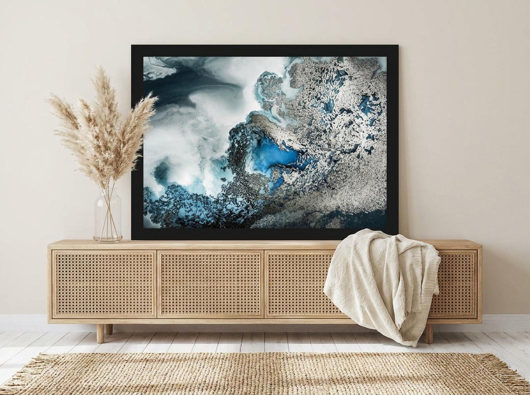Modern wall art print standing on a sideboard in a coastal home office