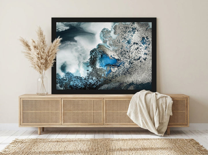 Modern wall art print standing on a sideboard in a coastal home office