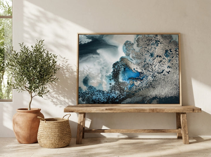 Canvas wall art with a natural timber surround standing on a bench in a Mediterranean home office