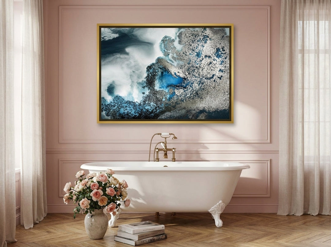 Canvas wall art with a gold leaf surround styled on the wall in a Parisian bathroom