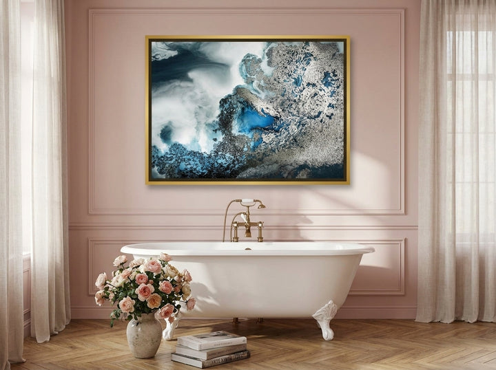 Canvas wall art with a gold leaf surround styled on the wall in a Parisian bathroom
