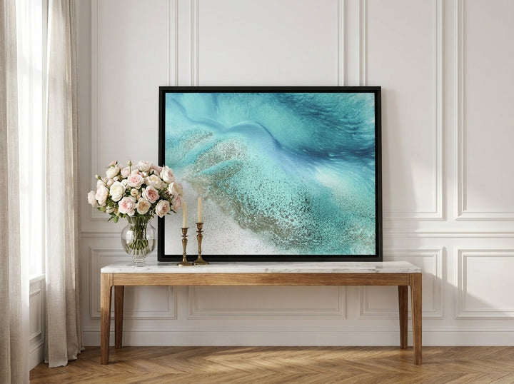 Canvas wall art with a black surround standing on a console in a Parisian bathroom
