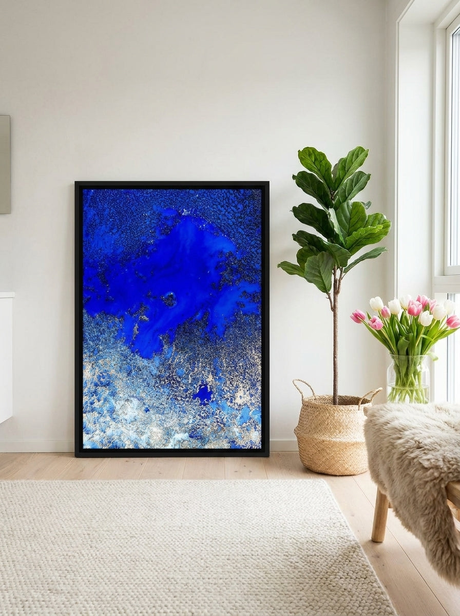 Canvas wall art with a black surround leaning against the wall in a bright Scandinavian bathroom