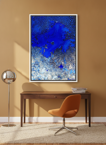 Canvas wall art with a white surround styled on the wall in a retro 70s home office