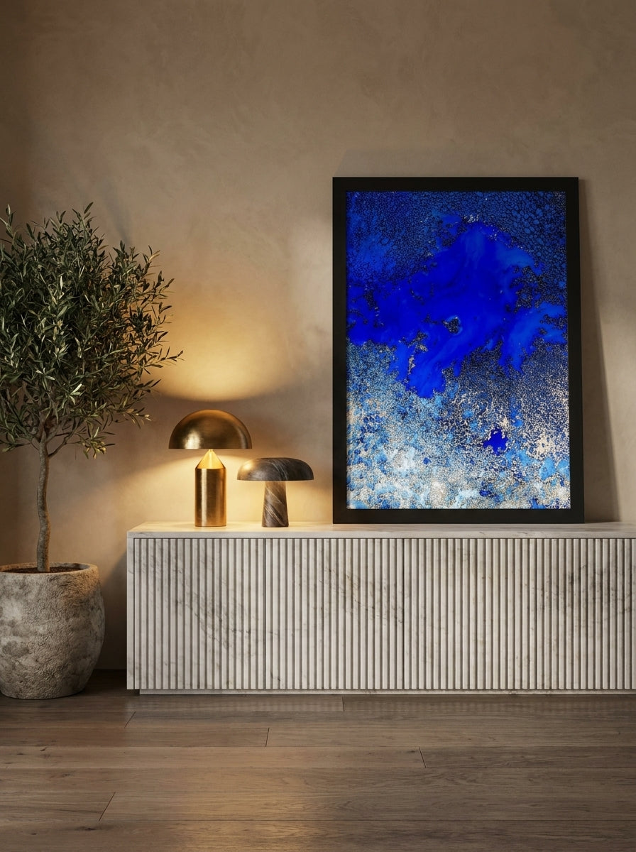 Modern wall art print standing on a sideboard in a luxe bedroom