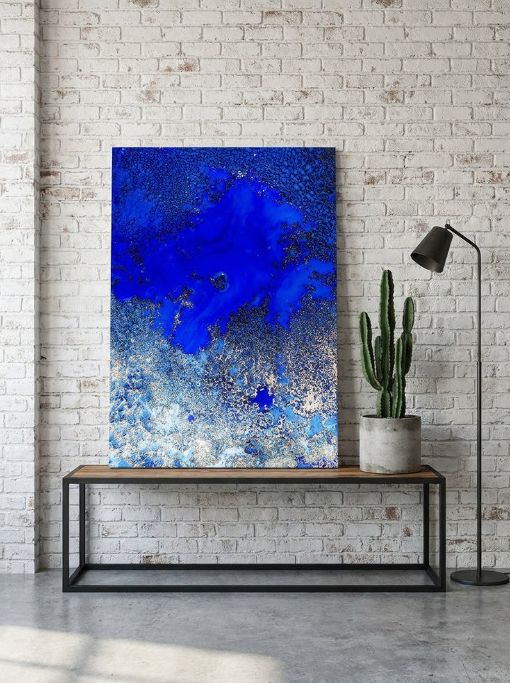 Stretched canvas wall art standing on a console in an industrial loft bedroom