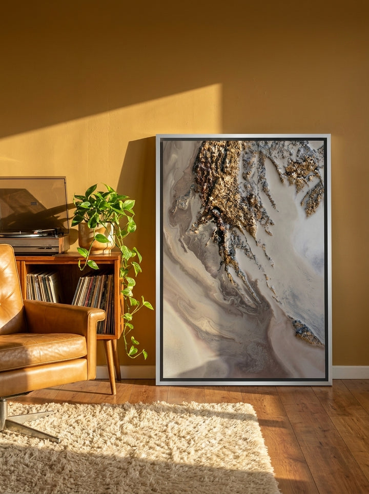 Canvas wall art with a silver leaf surround leaning against the wall in a retro 70s home office