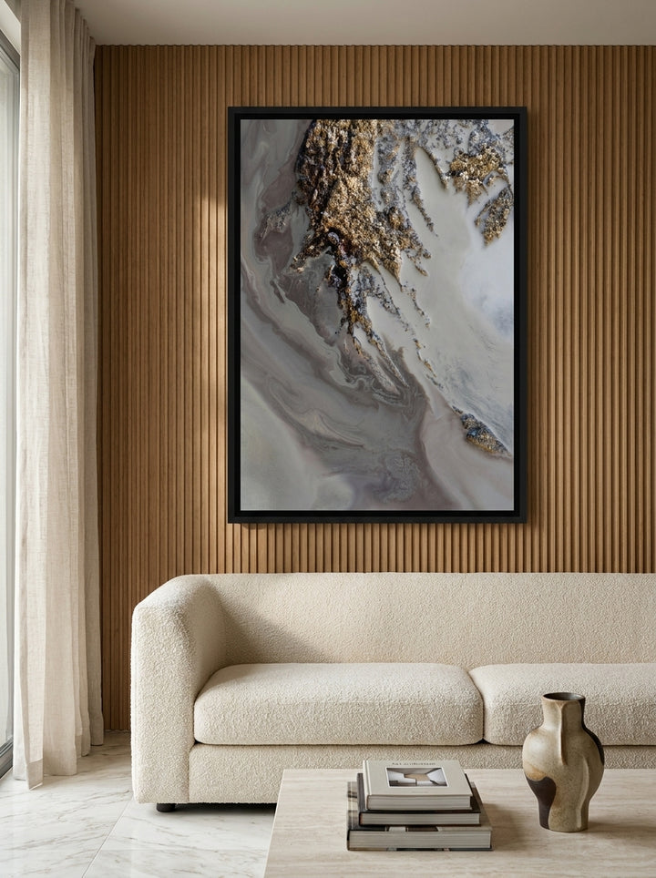 Oversized statement canvas wall art with a black surround styled on the wall in a luxe living room