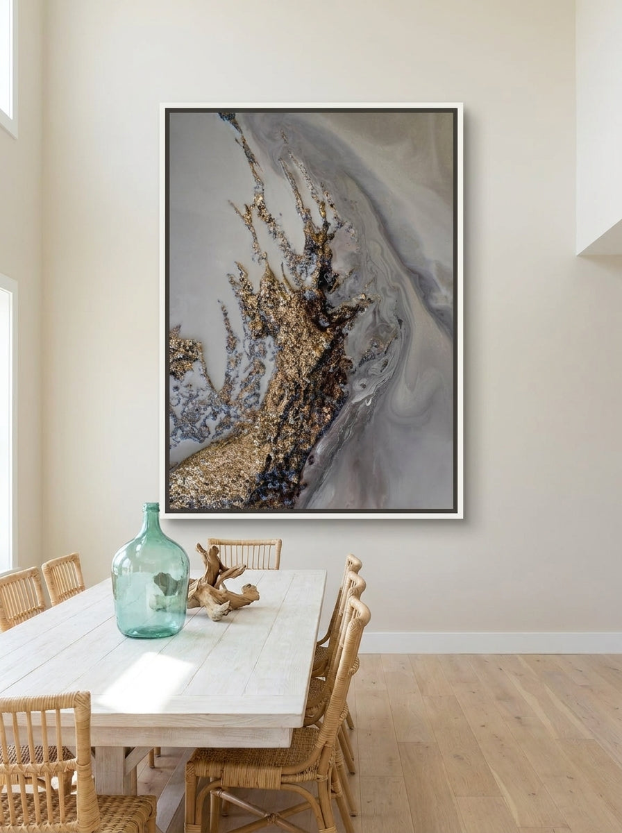 Oversized statement canvas wall art with a white surround styled on the wall in a coastal dining room