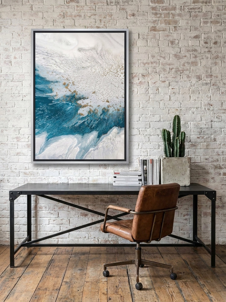 Canvas wall art with a silver leaf surround styled on the wall in an industrial loft home office