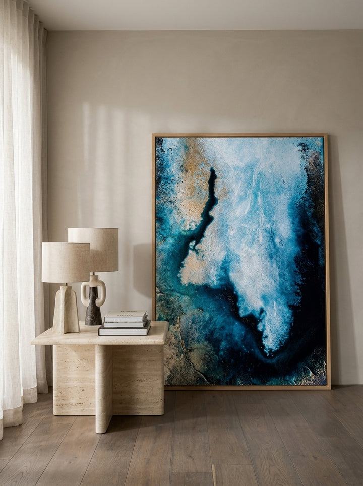 Oversized statement modern wall art print leaning against the wall in a luxe dining room