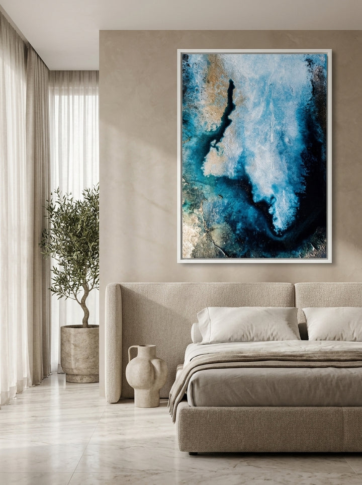 Oversized statement canvas wall art with a white surround styled on the wall in a luxe bedroom