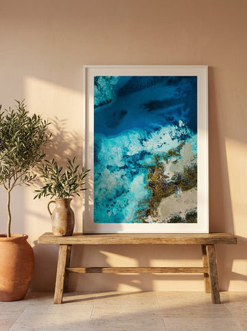 Modern wall art print standing on a bench in a Mediterranean bedroom