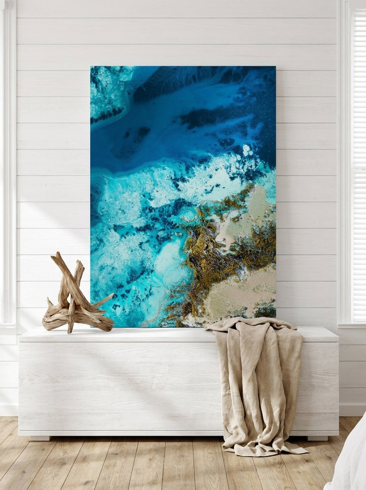 Stretched canvas wall art standing on a console in a coastal bedroom