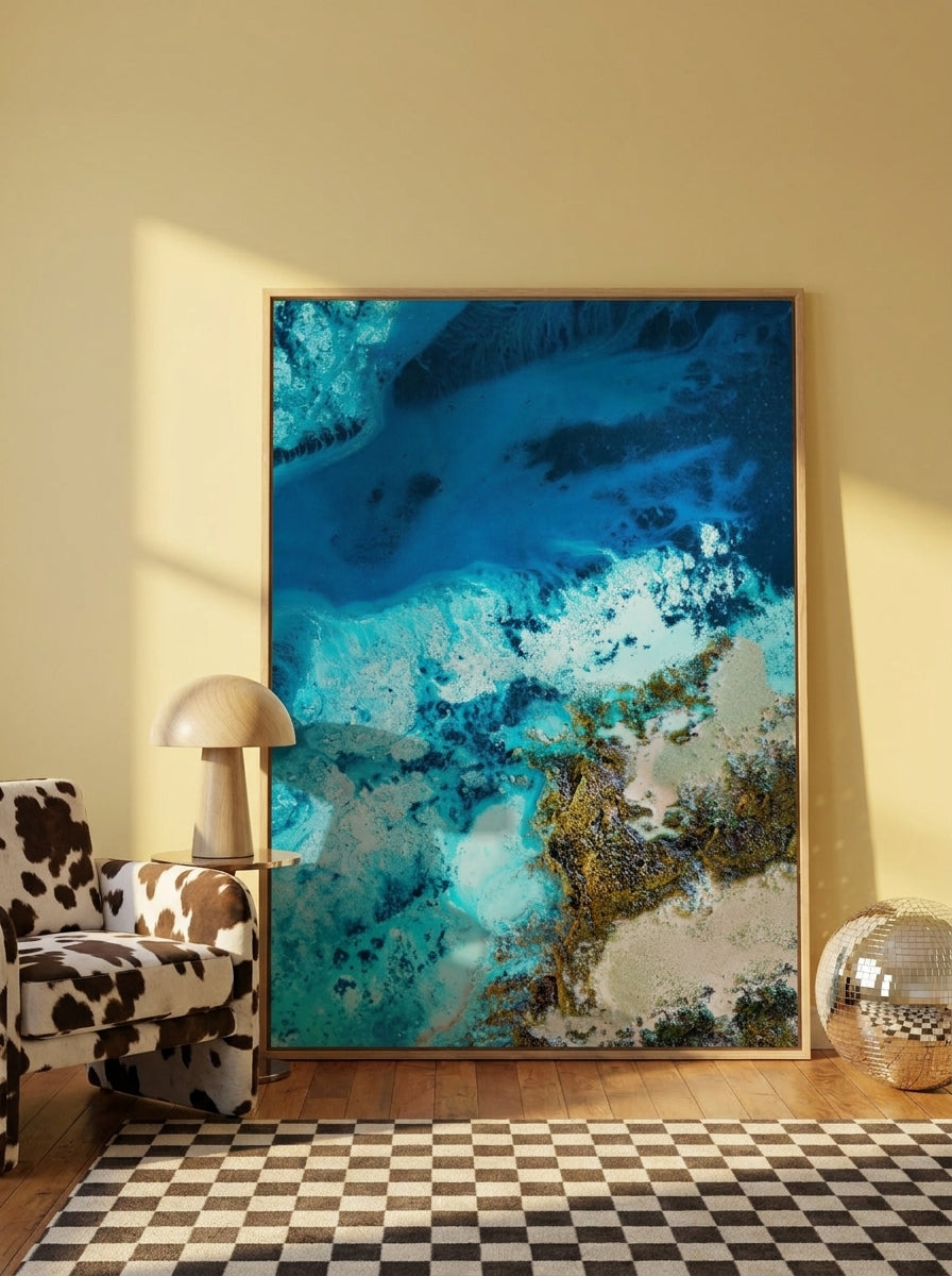 Oversized statement canvas wall art with a natural timber surround leaning against the wall in a colourful eclectic living room