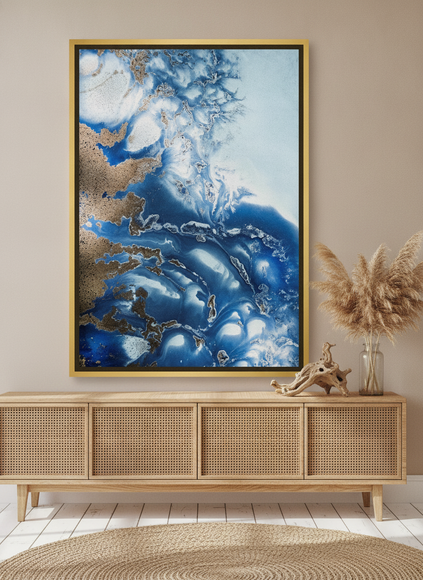 Canvas wall art with a gold leaf surround standing on a sideboard in a coastal bathroom