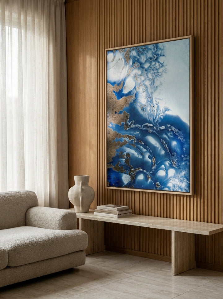Oversized statement canvas wall art with a natural timber surround styled on the wall in a luxe living room
