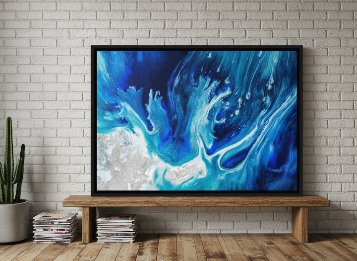 Canvas wall art with a black surround standing on a bench in an industrial loft home office