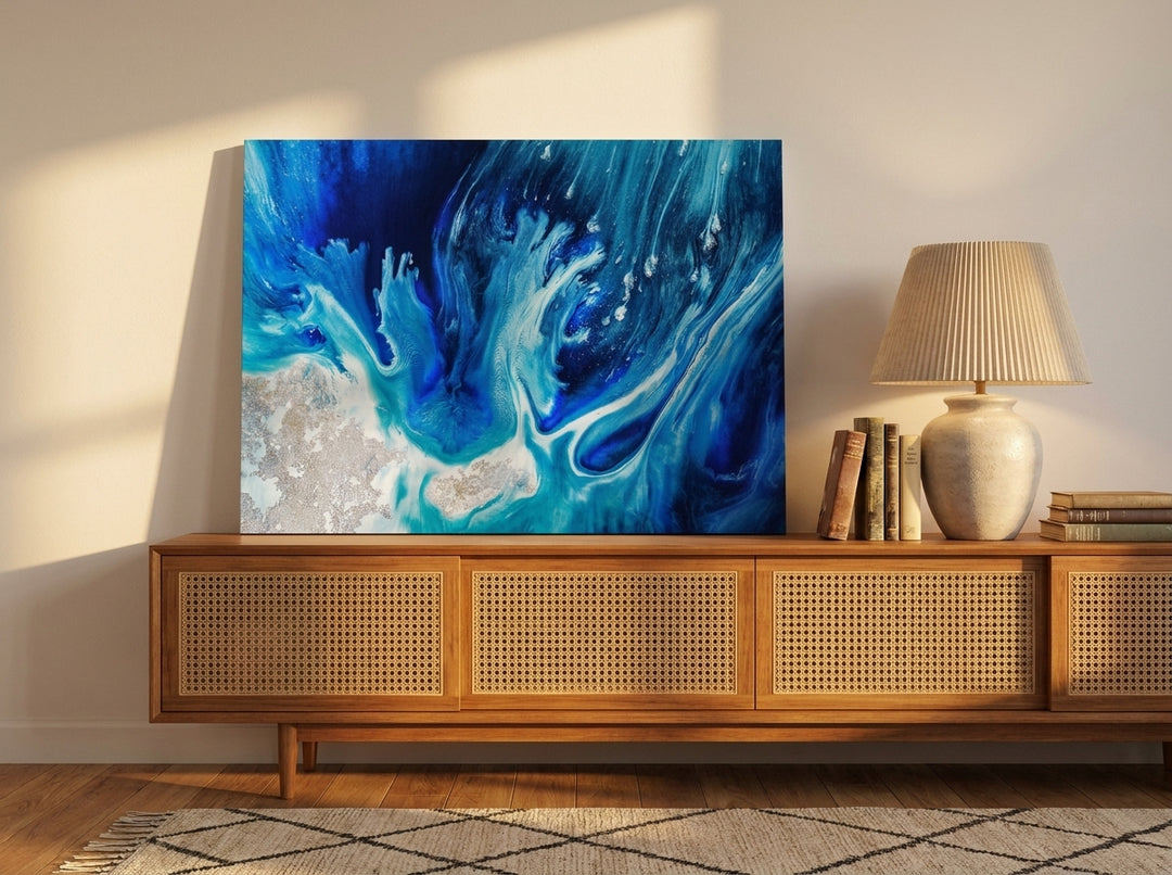 Stretched canvas wall art standing on a sideboard in a mid-century living room