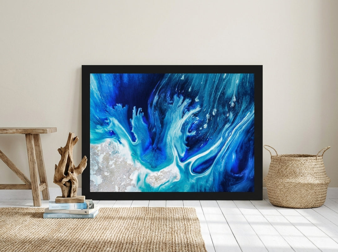 Oversized statement modern wall art print leaning against the wall in a coastal living room