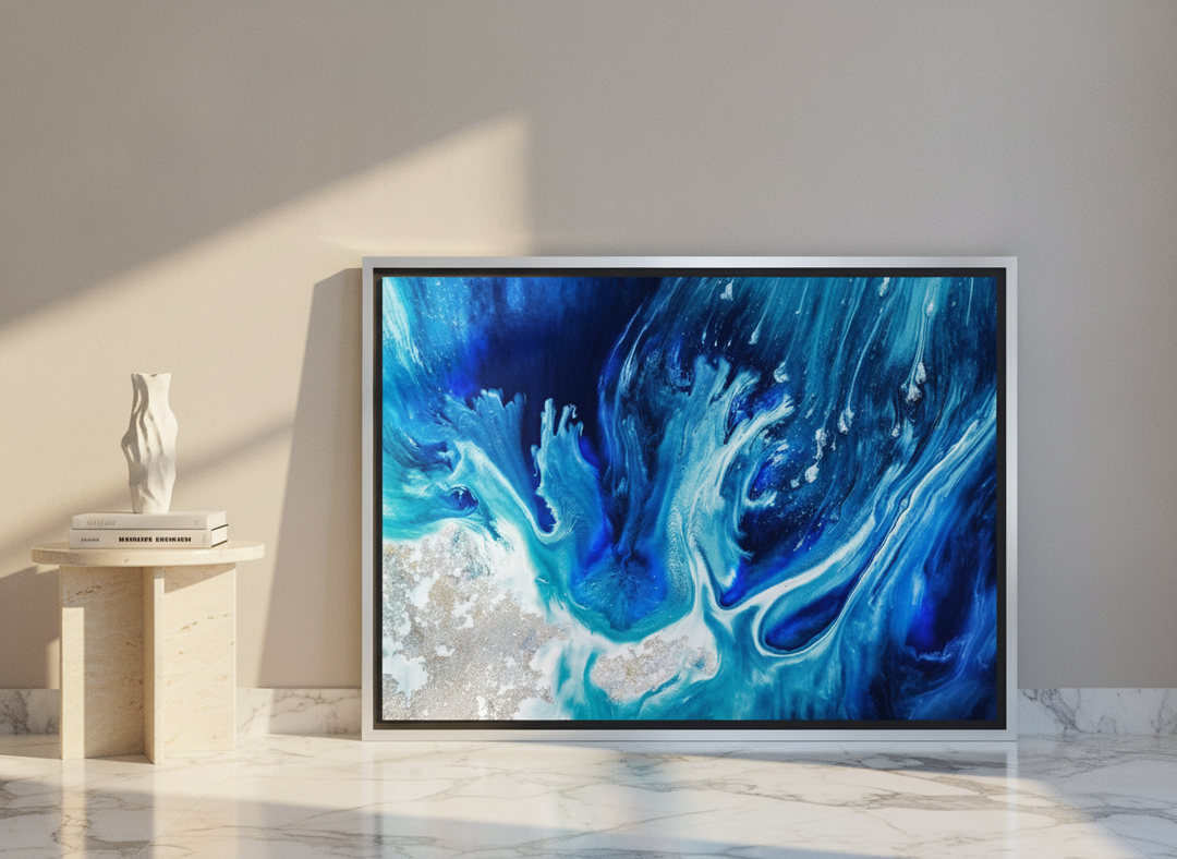Canvas wall art with a silver leaf surround leaning against the wall in a luxe living room