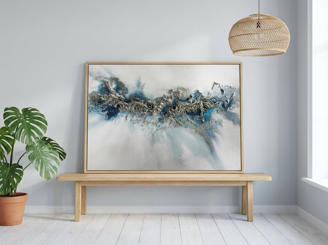 Modern wall art print standing on a bench in a bright Scandinavian home office