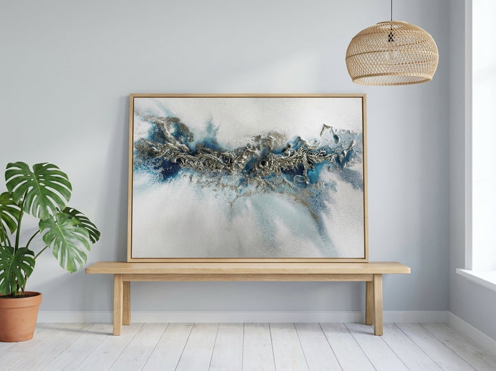 Modern wall art print standing on a bench in a bright Scandinavian home office