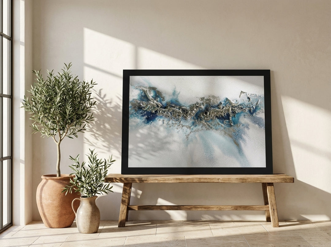 Modern wall art print standing on a bench in a Mediterranean bathroom
