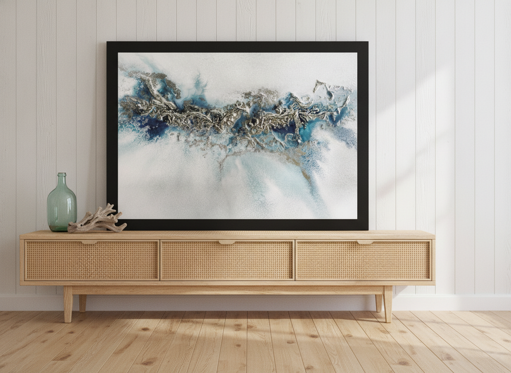 Modern wall art print standing on a sideboard in a coastal bedroom