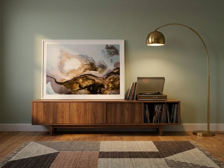 Modern wall art print standing on a sideboard in a mid-century home office