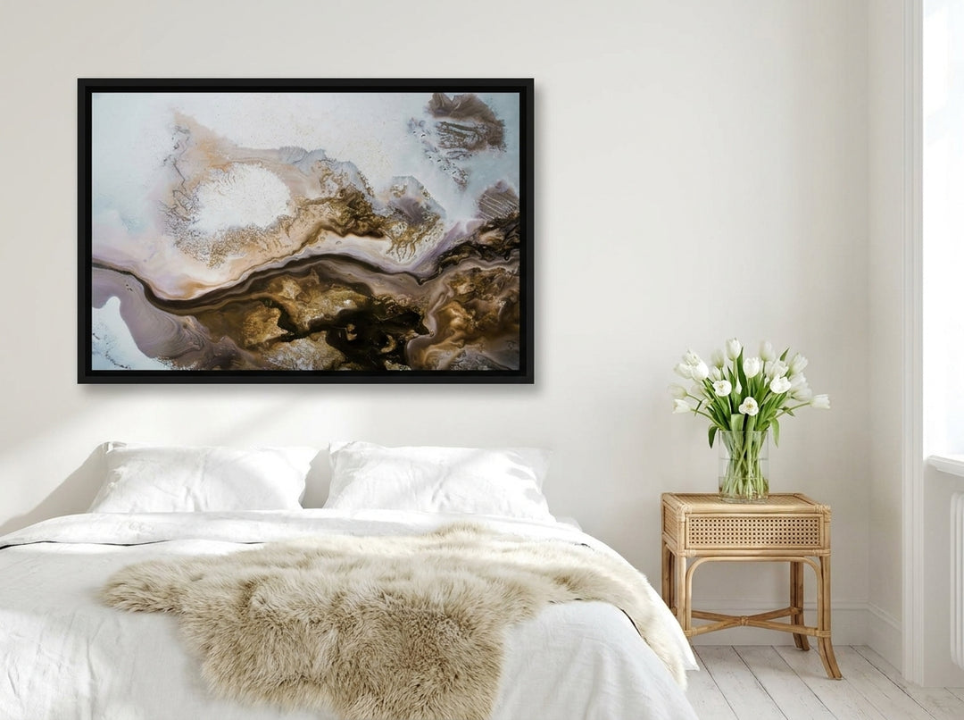 Canvas wall art with a black surround styled on the wall in a bright Scandinavian bedroom