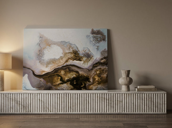 Stretched canvas wall art standing on a sideboard in a luxe bedroom