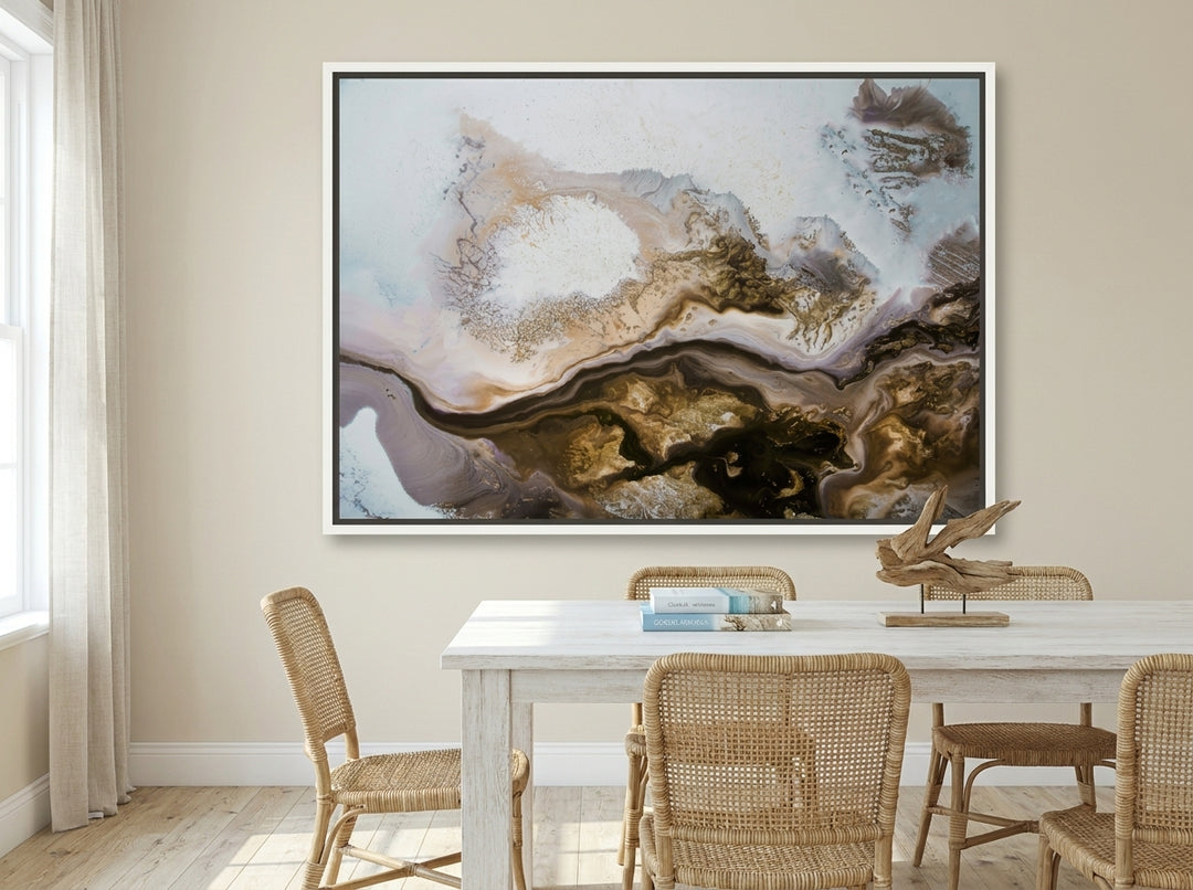 Oversized statement canvas wall art with a white surround styled on the wall in a coastal dining room