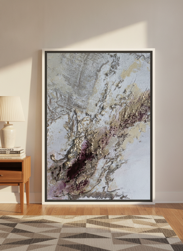 Oversized statement canvas wall art with a white surround leaning against the wall in a mid-century dining room