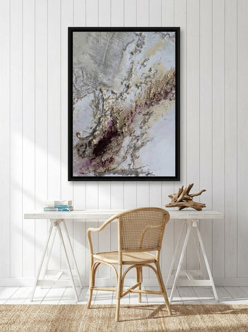 Canvas wall art with a black surround styled on the wall in a coastal home office