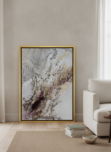 Canvas wall art with a gold leaf surround leaning against the wall in a warm Japandi living room