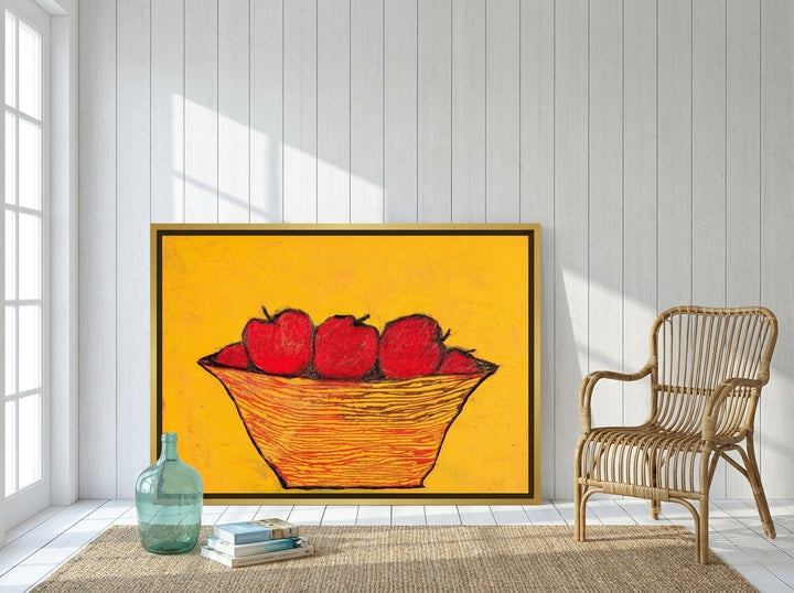 Oversized statement canvas wall art with a gold leaf surround leaning against the wall in a coastal dining room