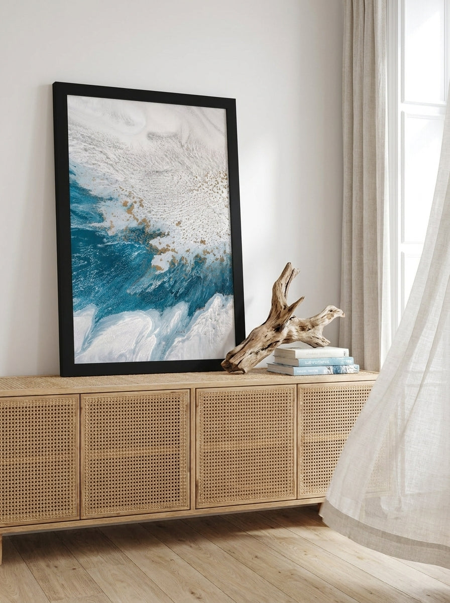 Modern wall art print standing on a sideboard in a coastal bedroom