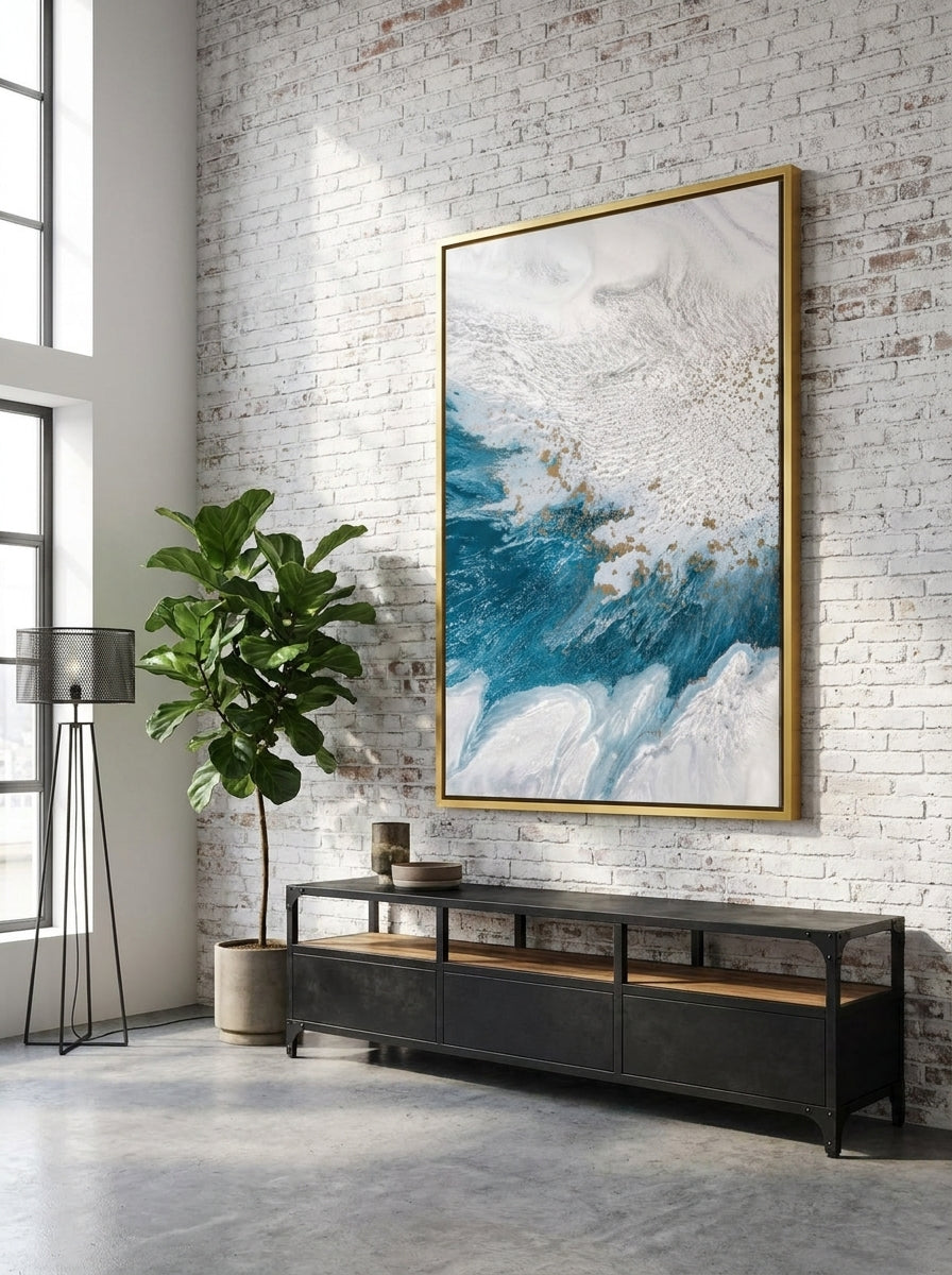 Oversized statement canvas wall art with a gold leaf surround styled on the wall in an industrial loft living room