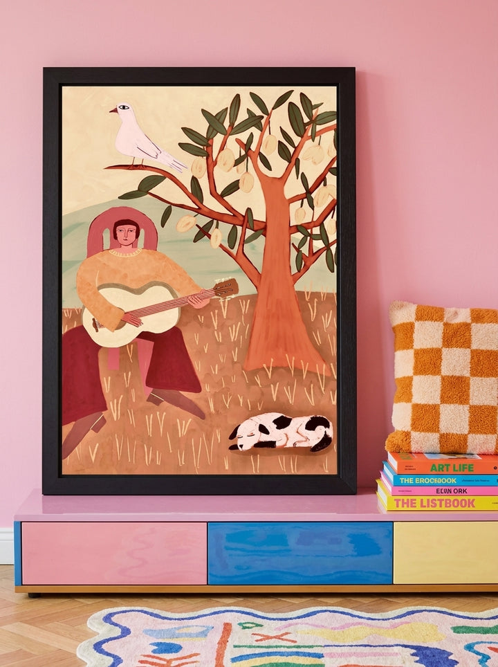 Modern wall art print standing on a sideboard in a colourful eclectic bedroom