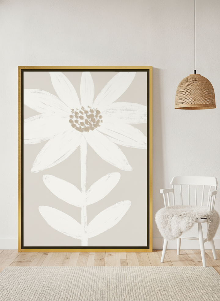 Canvas wall art with a gold leaf surround leaning against the wall in a bright Scandinavian nursery