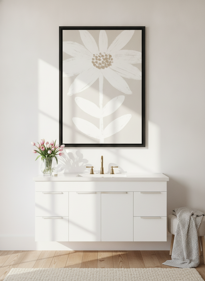 Canvas wall art with a black surround styled on the wall in a bright Scandinavian bathroom