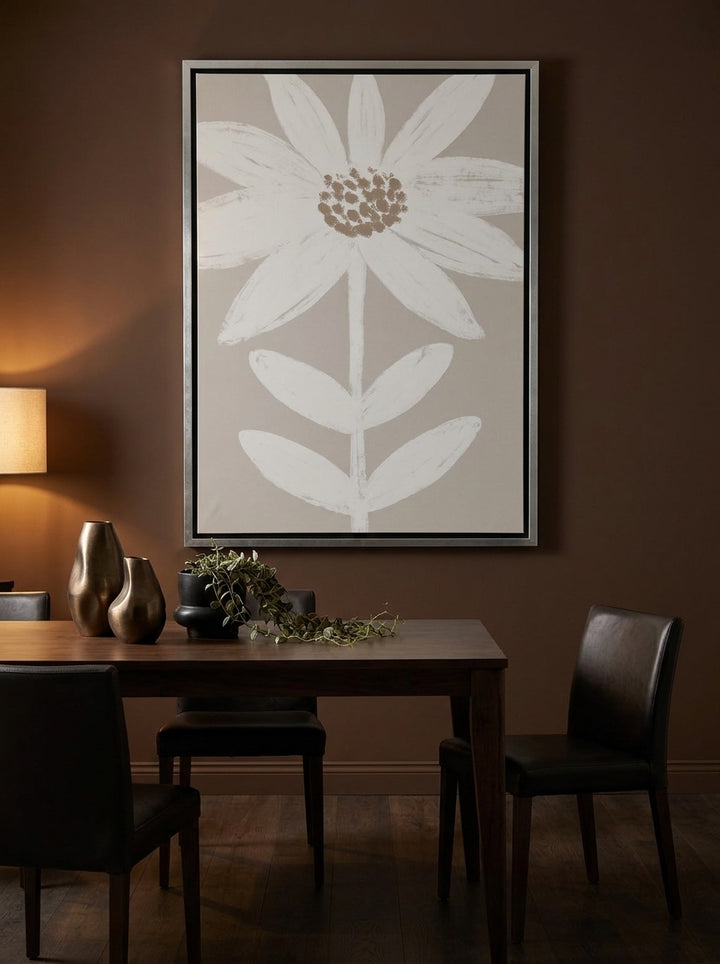 Oversized statement canvas wall art with a silver leaf surround styled on the wall in a moody dining room