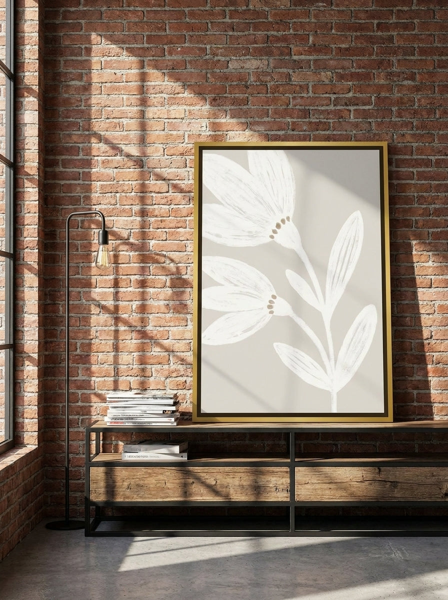 Canvas wall art with a gold leaf surround standing on a console in an industrial loft bedroom