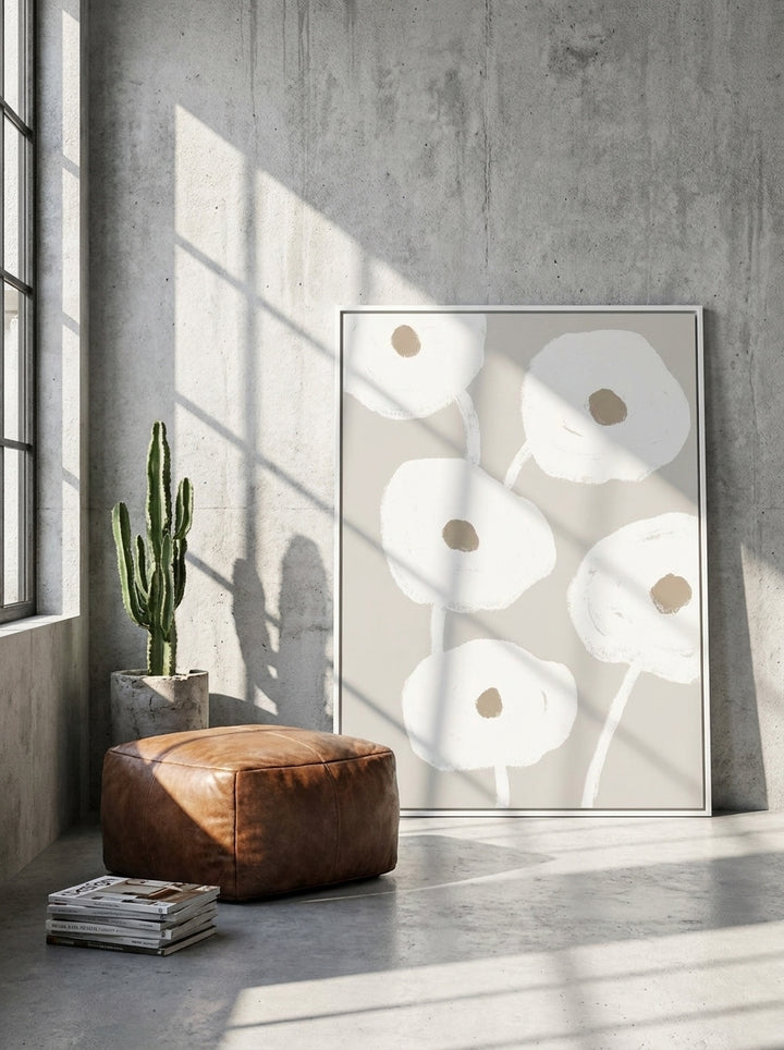 Oversized statement canvas wall art with a white surround leaning against the wall in an industrial loft dining room