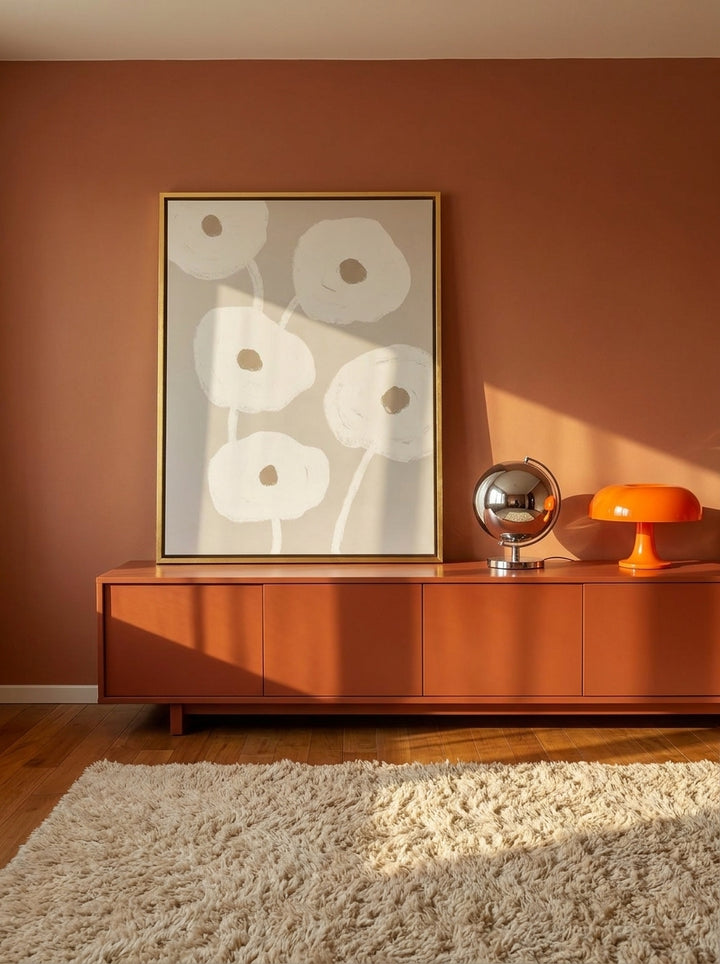 Canvas wall art with a gold leaf surround standing on a sideboard in a retro 70s bedroom