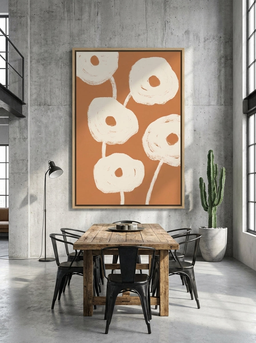 Oversized statement canvas wall art with a natural timber surround styled on the wall in an industrial loft dining room